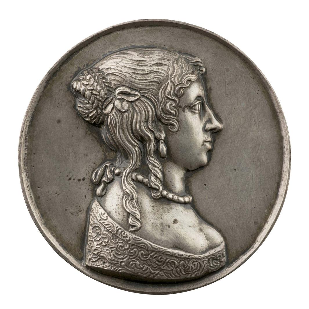Silver portrait medal of Dorcas Brabazon, Lady Lane with ringlets of hair falling from her braided chignon onto her shoulder, wearing a pearl tear-drop earring, pearl necklace, and a lace-trimmed or embroidered gown, with shoulders and décolletage exposed 