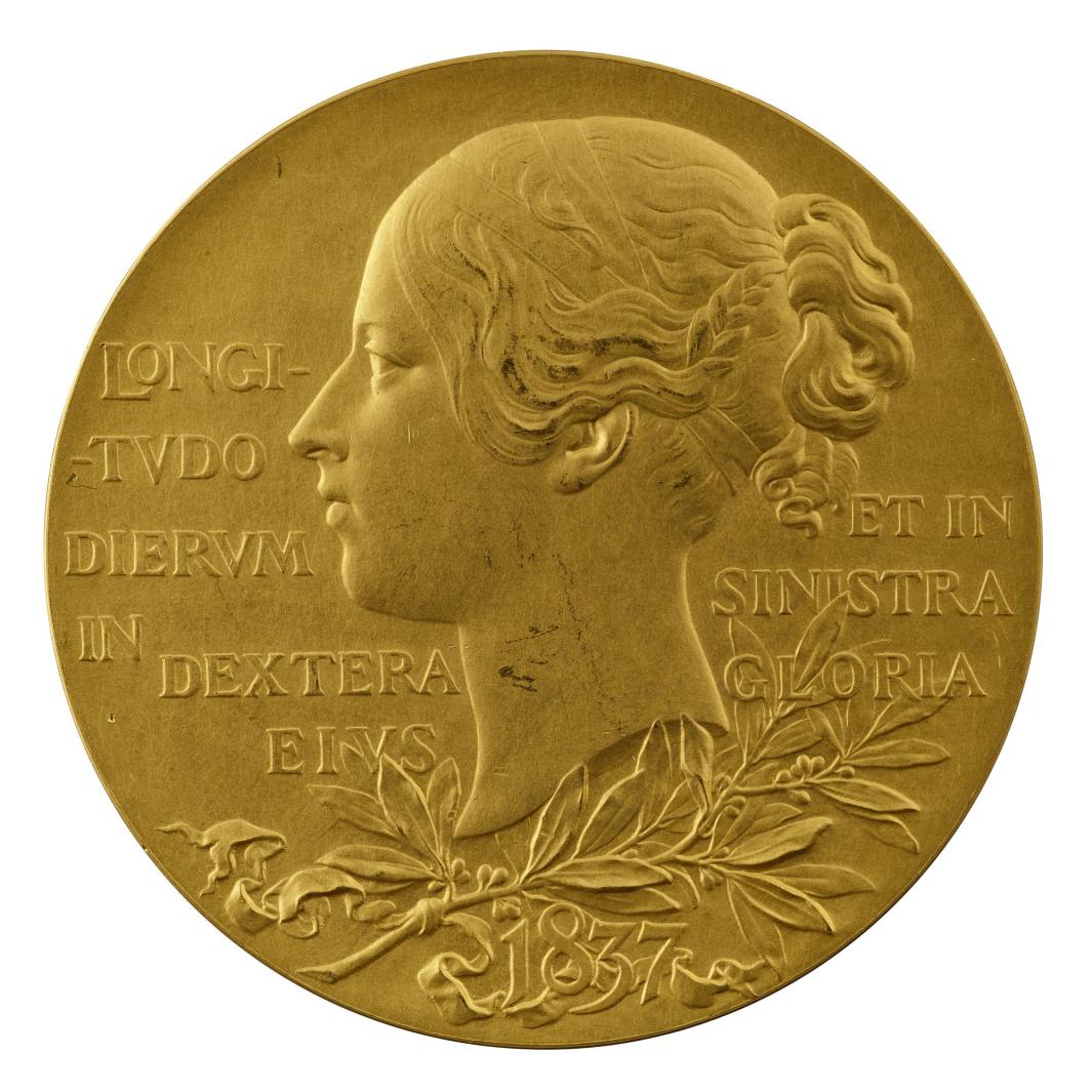 Gold portrait medal of the young Queen Victoria, hair drawn back into a loose knot, with a simple fillet worn around the full part of the head; beneath her, a branch of laurels tied with a ribbon 