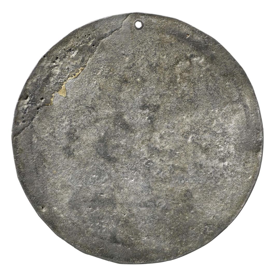 Unmarked lead reverse of a medal 