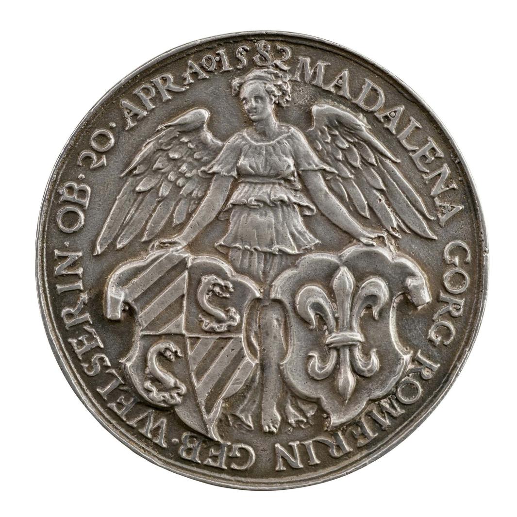 Silver medal depicting a winged woman holding two shields
