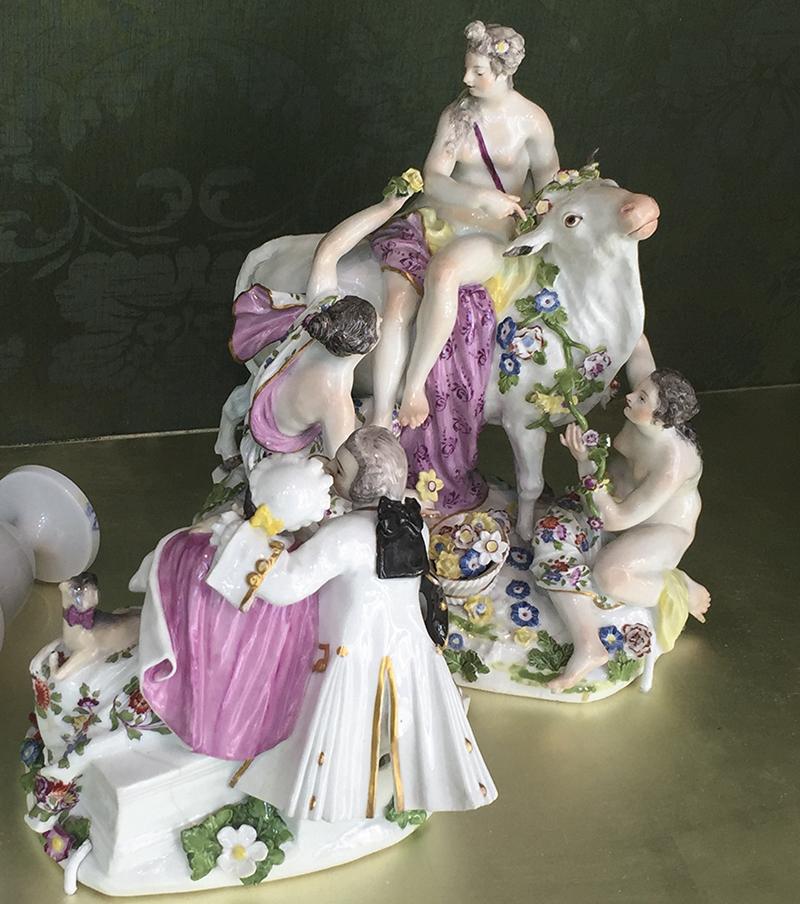colored porcelain of woman figure seated on bull surrounded by four other figures