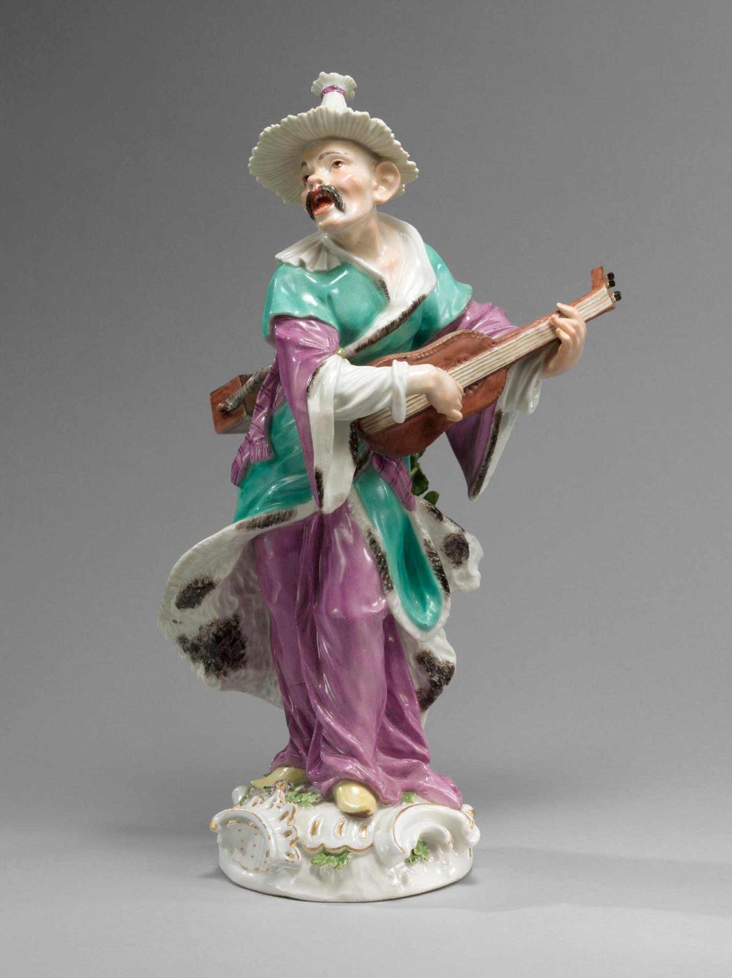 colorful porcelain male figure holding musical instrument