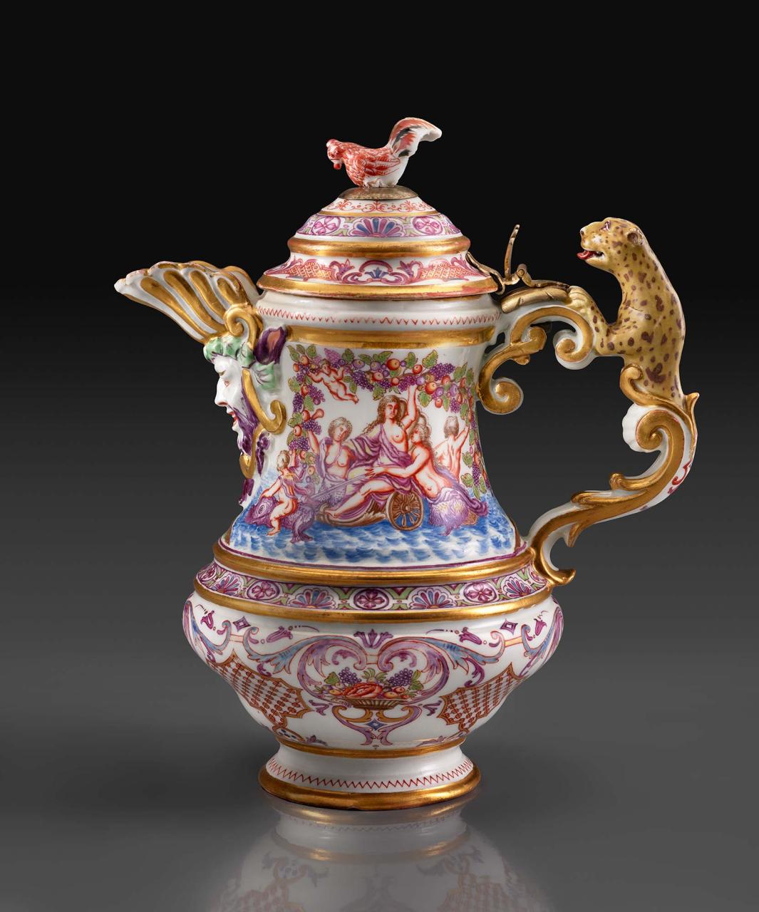 colorful porcelain pitcher accented with a leopard handle, a male face at front, a chicken at the top and scene of mermaids, possibly