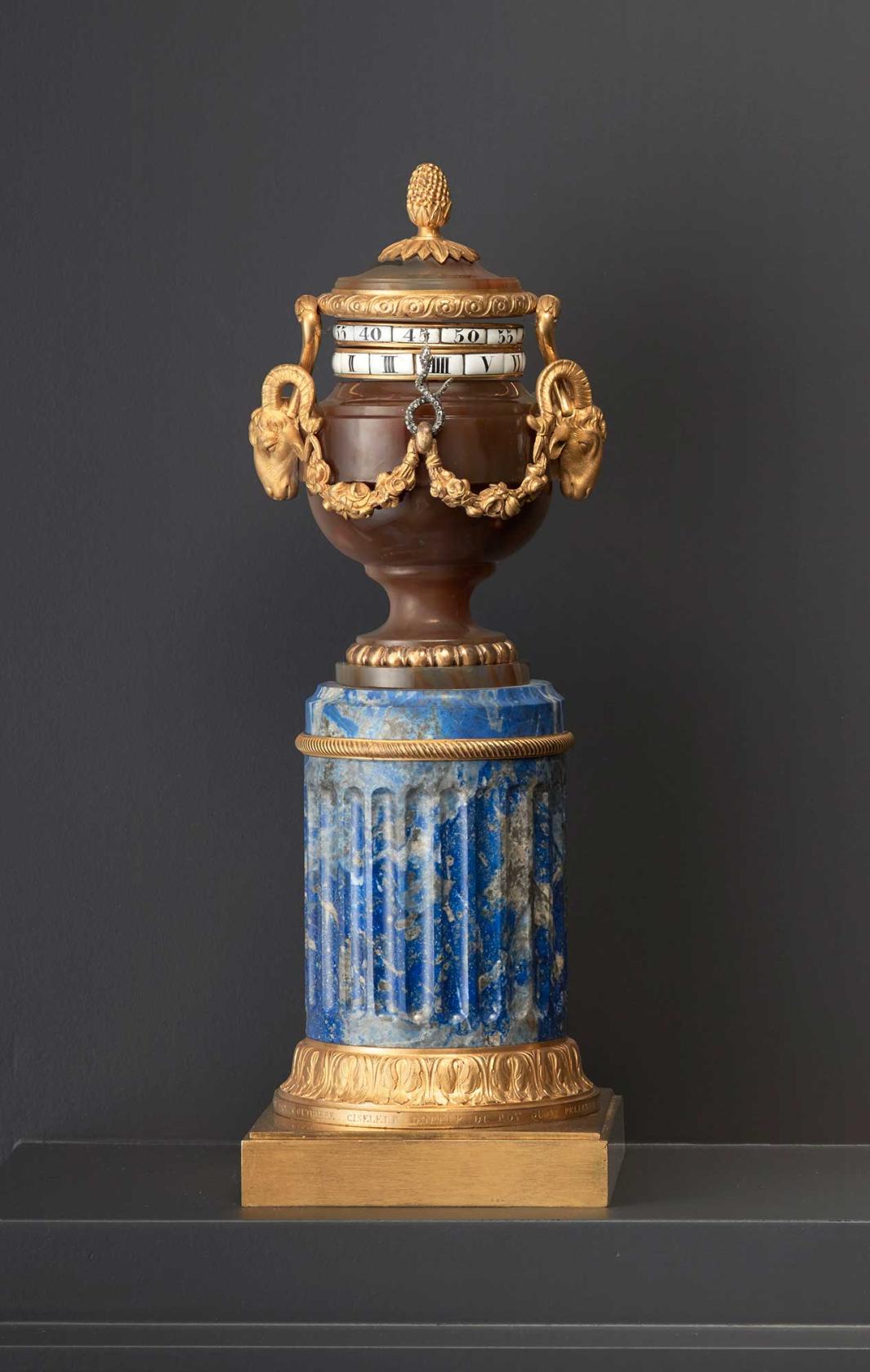 small standing clock, with horizontal rotating time dials, decorated with gilt-bronze, agate and enamel