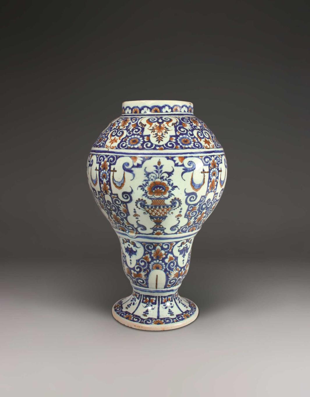 Earthenware vase with a floral motif in blue and orange.