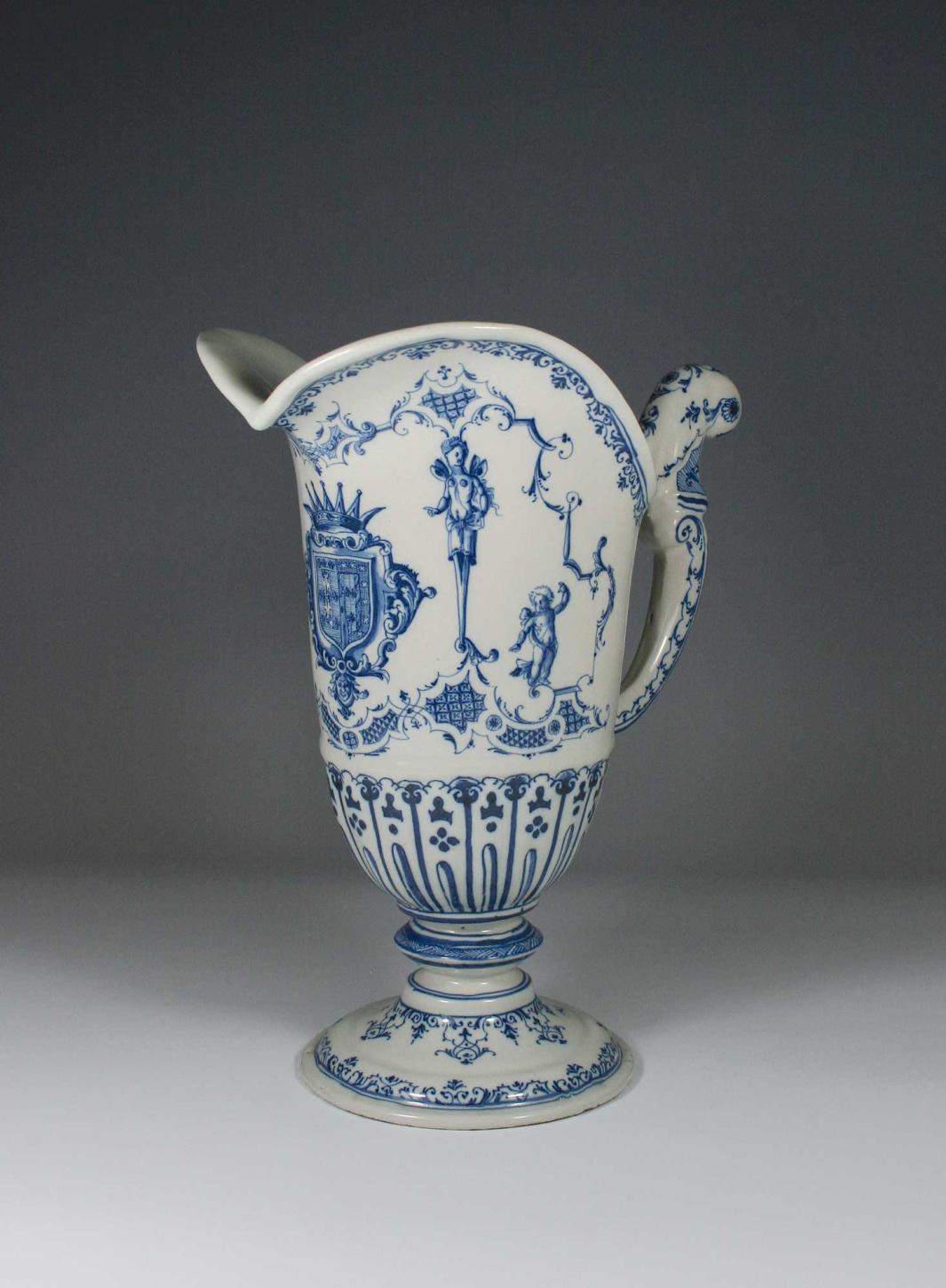 Earthenware ewer in blue and white with a coat of arms and two figures.