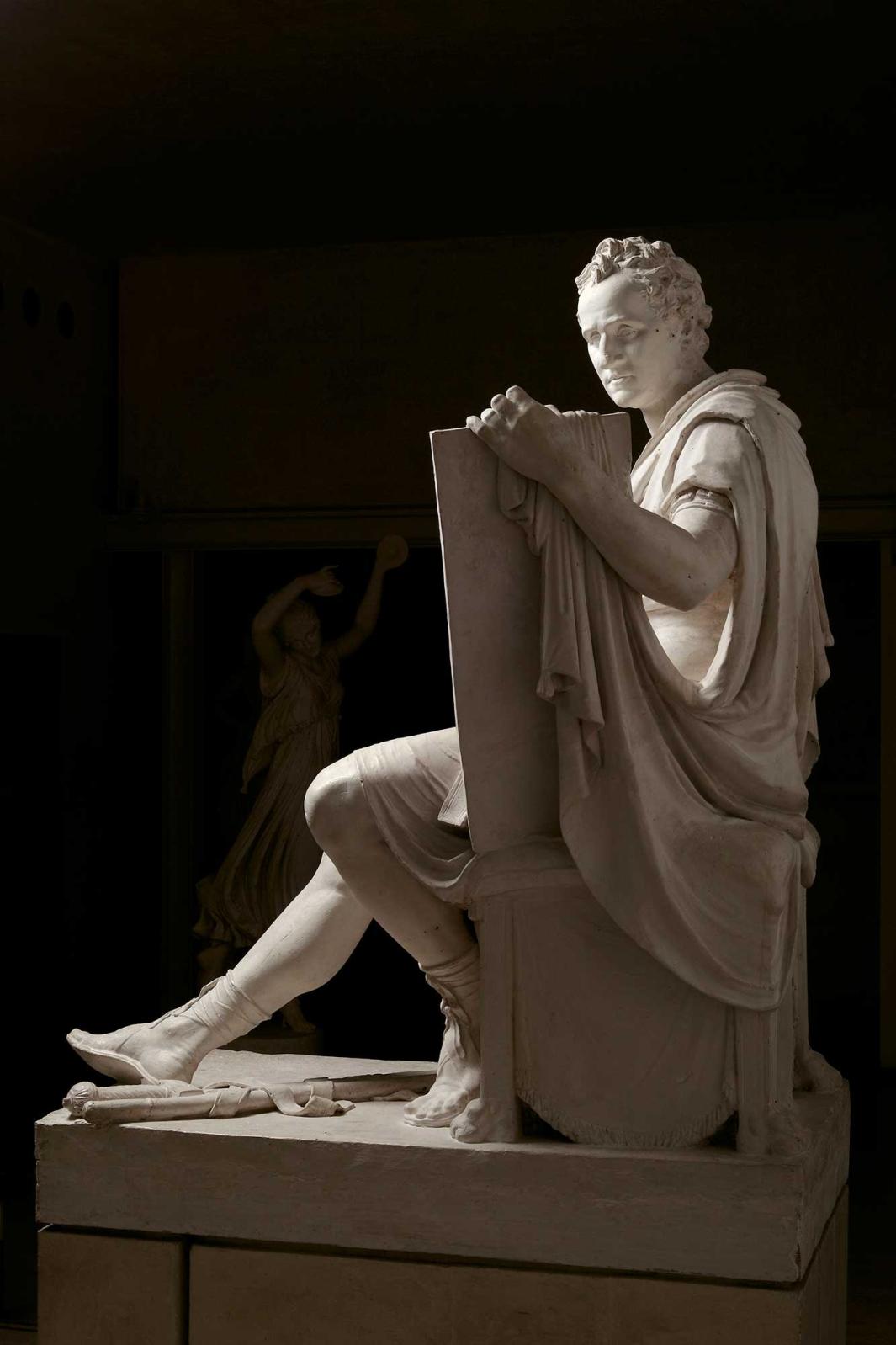 sculpture of George Washington seated holding tablet