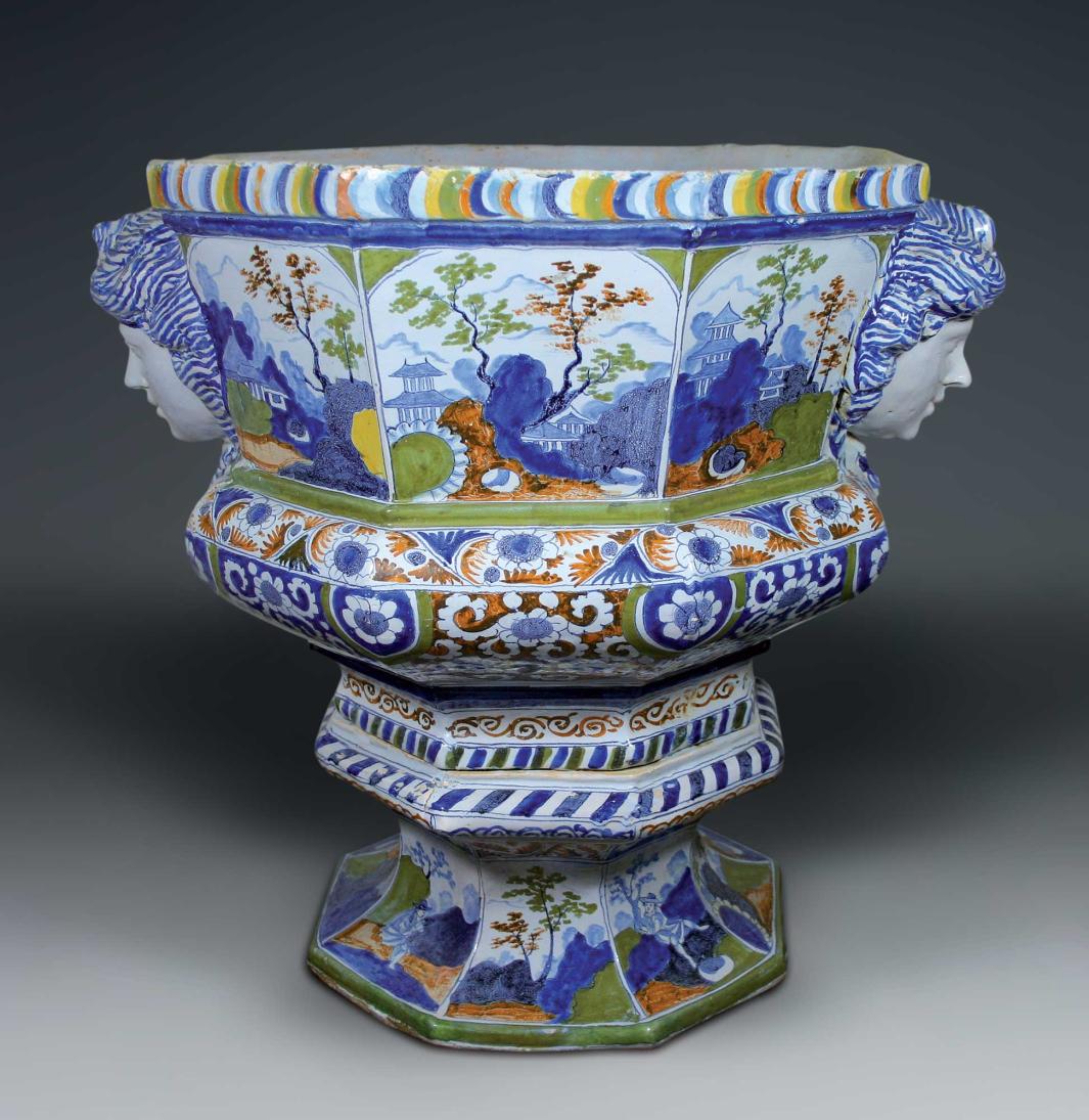 Earthenware planter in blue, green, and orange with landscape scenes and two raised portraits