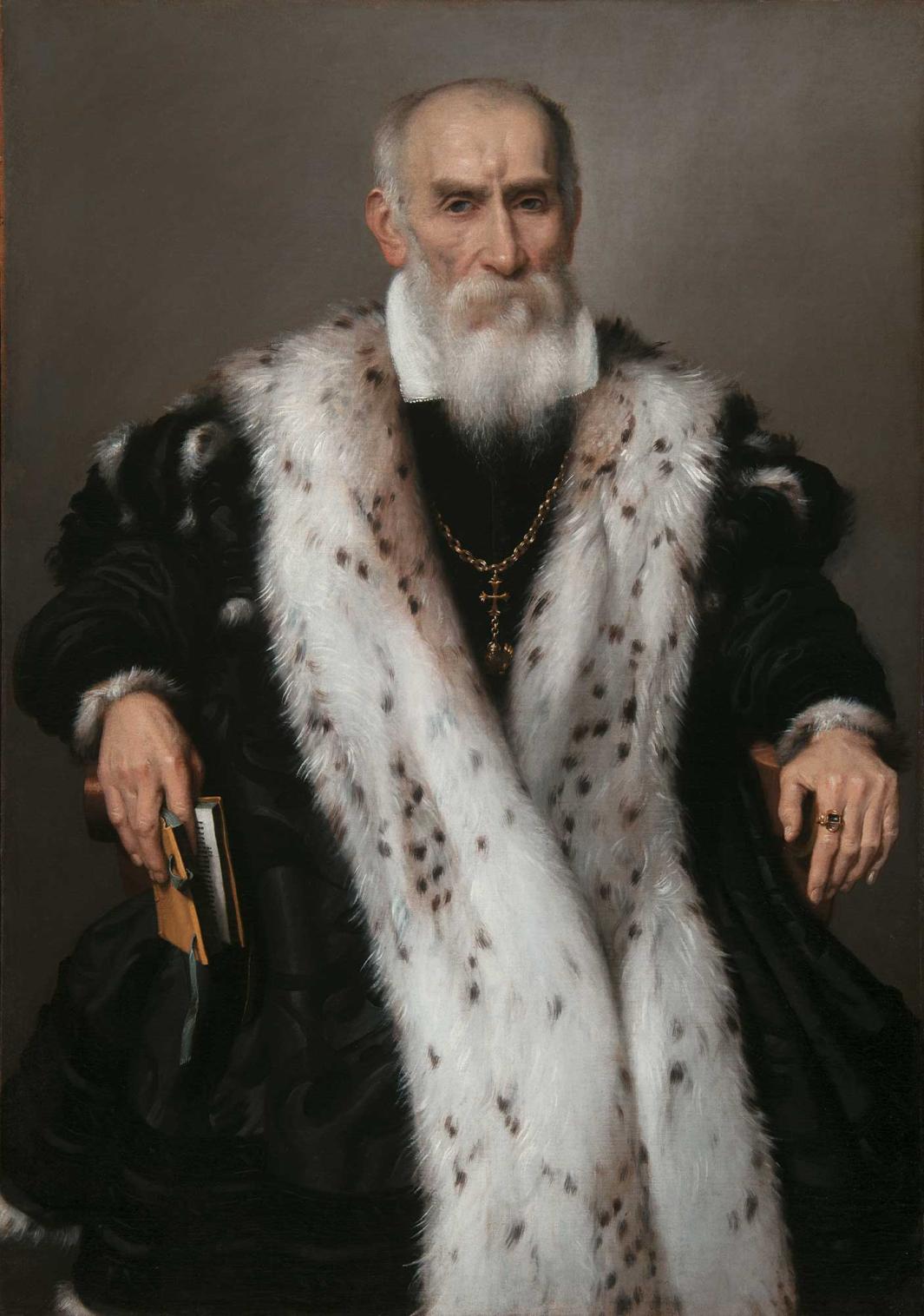oil painting of elderly man sitting. He wears a heavy black cloak lined with white ermine fur.