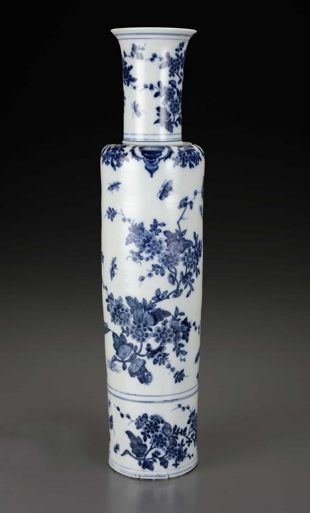 View of a pair of large cylindrical porcelain vases with floral motifs in blue glaze