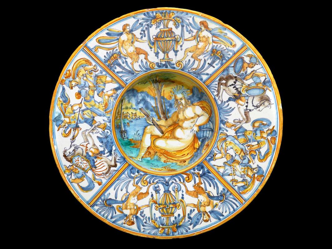 Earthenware plate with a large nude figure sitting in the center and soldiers in battle around the outside