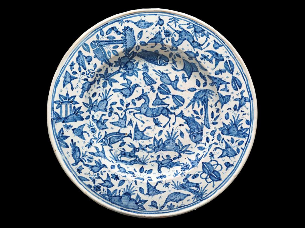 Earthenware plate with various plants and animals in blue and white