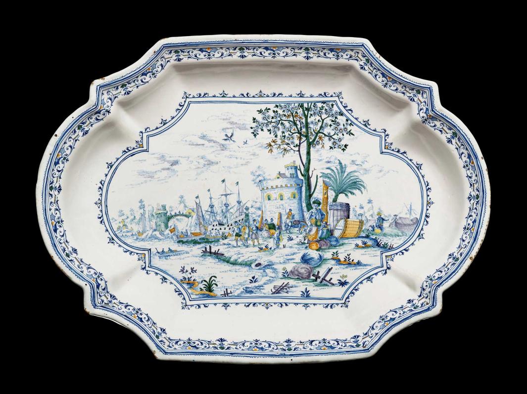 Earthenware platter depicting a landscape scene with soldiers in the foreground and castle and ships in the background