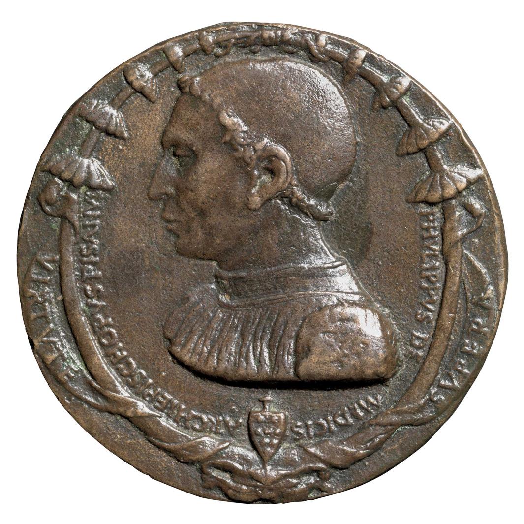Bronze medal depicting a man in profile.