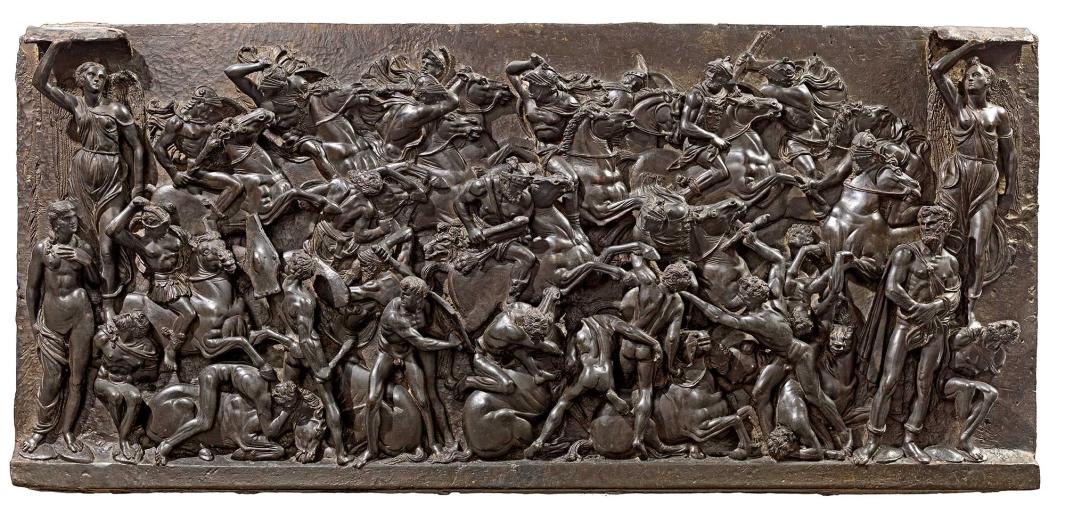 Bronze relief sculpture of a battle scene depicting nude or semi-nude soldiers attacking one another. Some soldiers are seated on horseback.