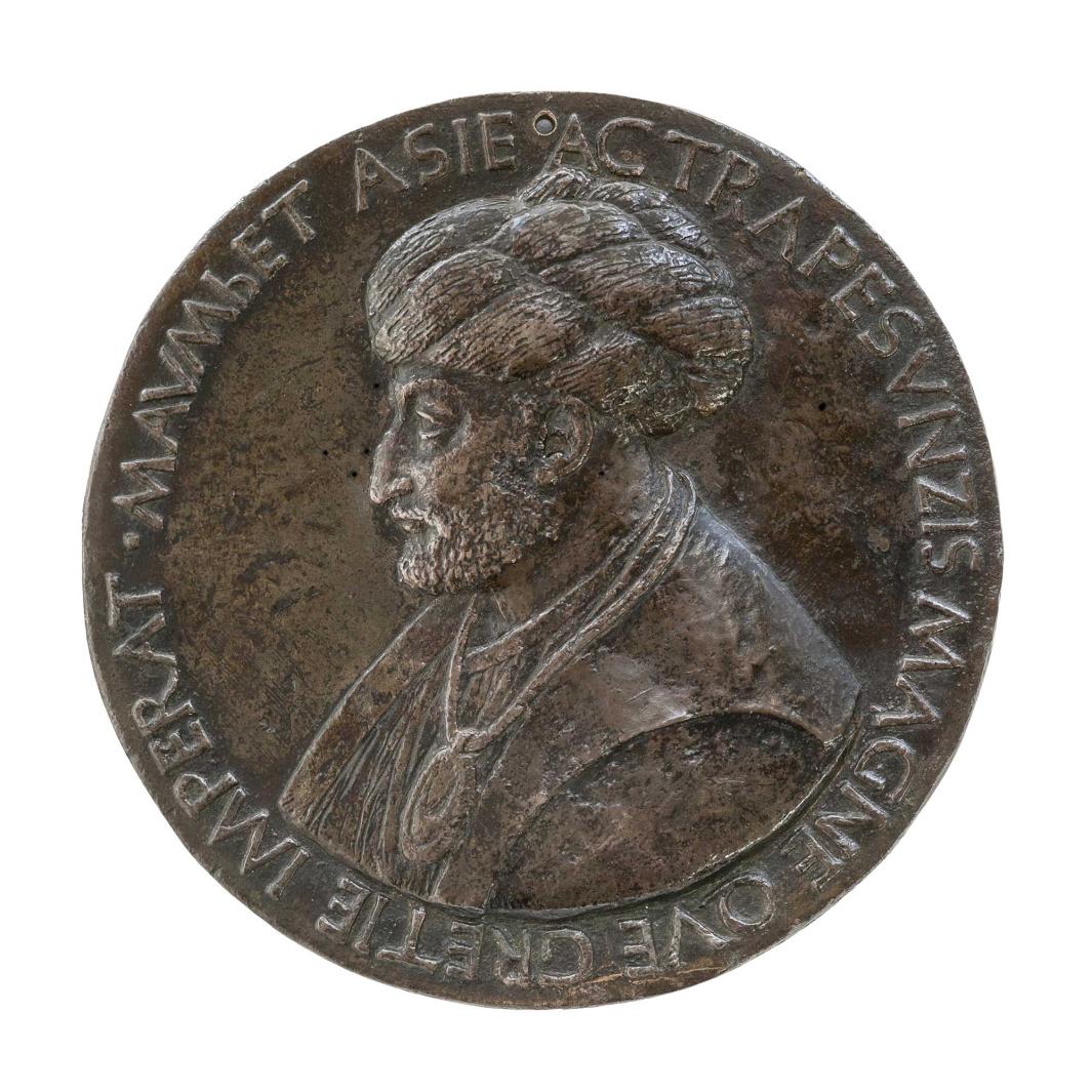 Bronze medal depicting a man in profile wearing a turban, and a large necklace.