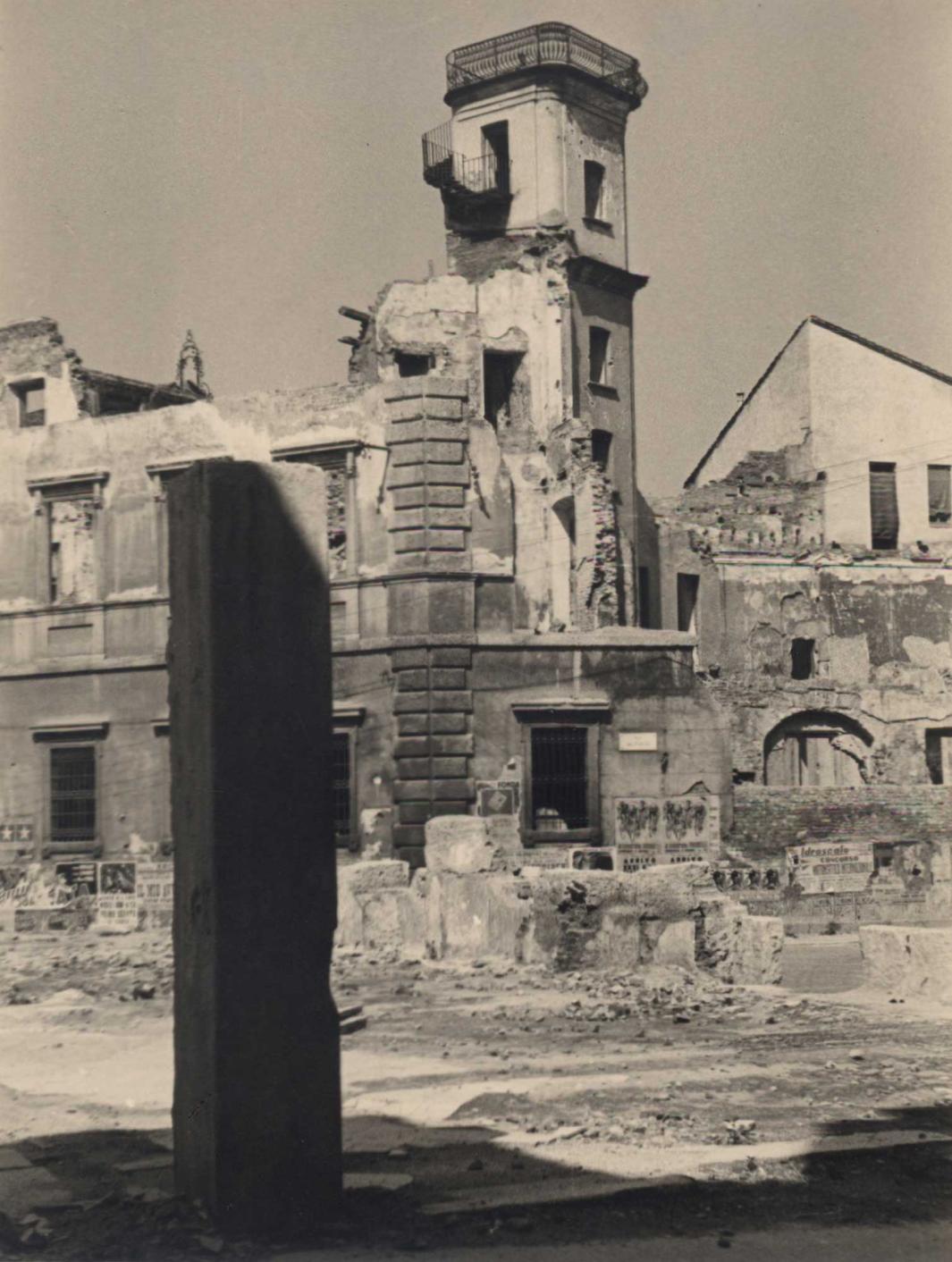 Photograph of a damaged building and tower.