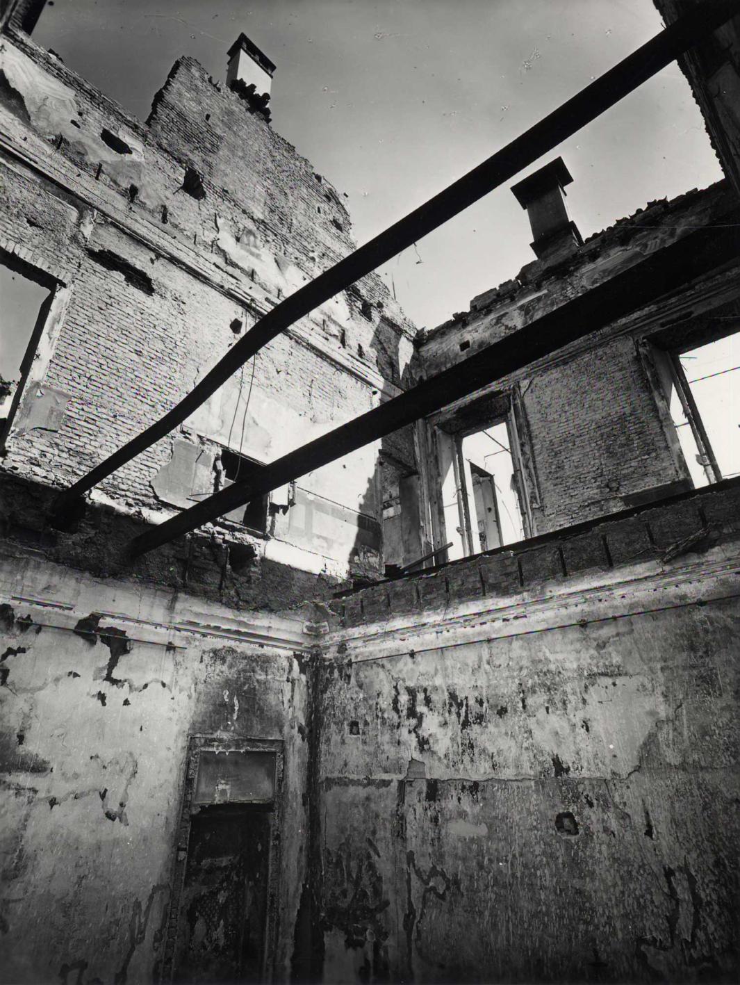 Photograph of the interior of a damaged building.