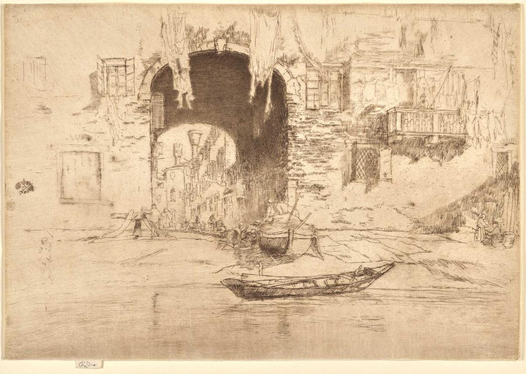 Archway over a canal with boats on the water