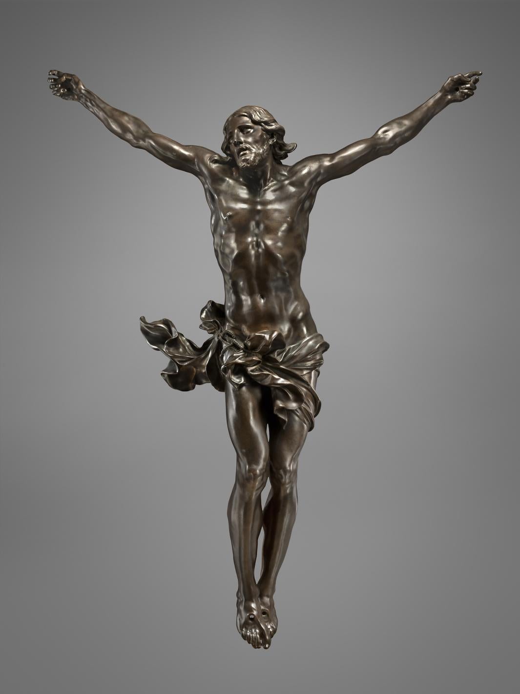 Bronze sculpture of Jesus Christ being crucified.