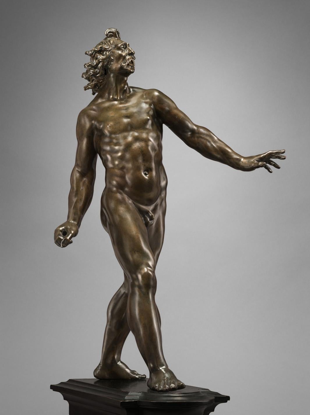Bronze statue of man striding forward.