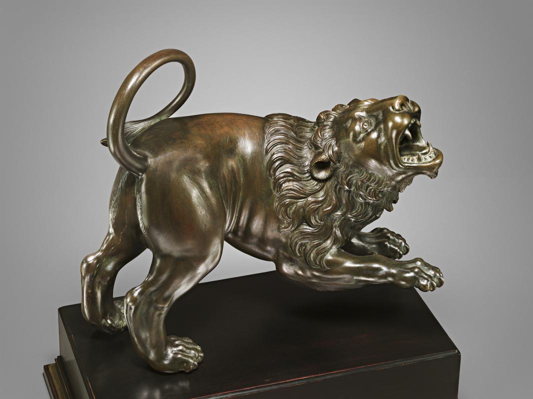 Bronze sculpture of a roaring lion.