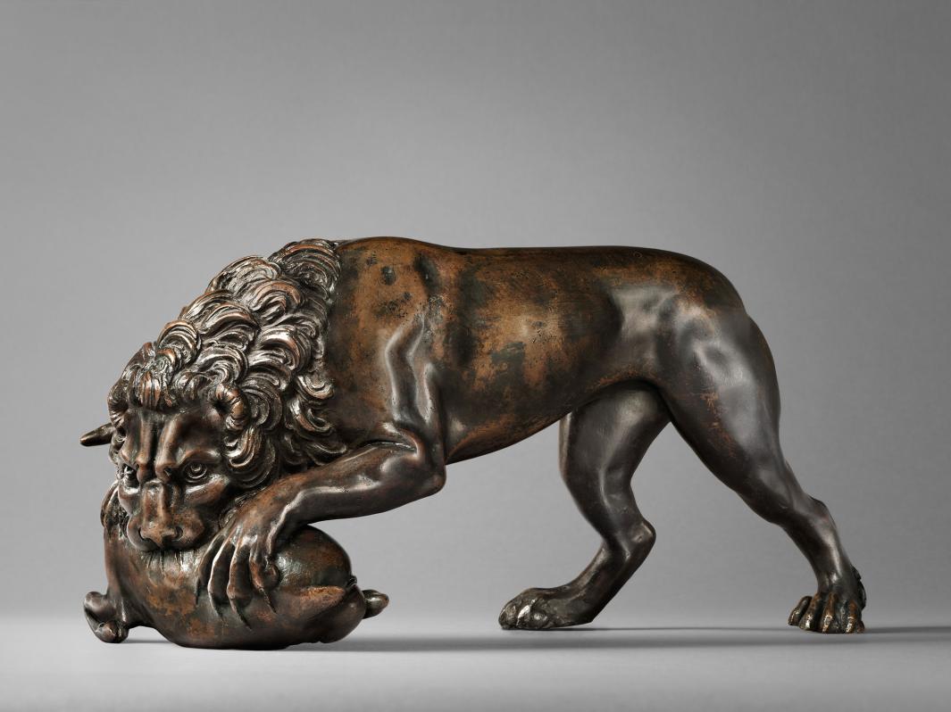 Bronze sculpture of a lion devouring a doe.