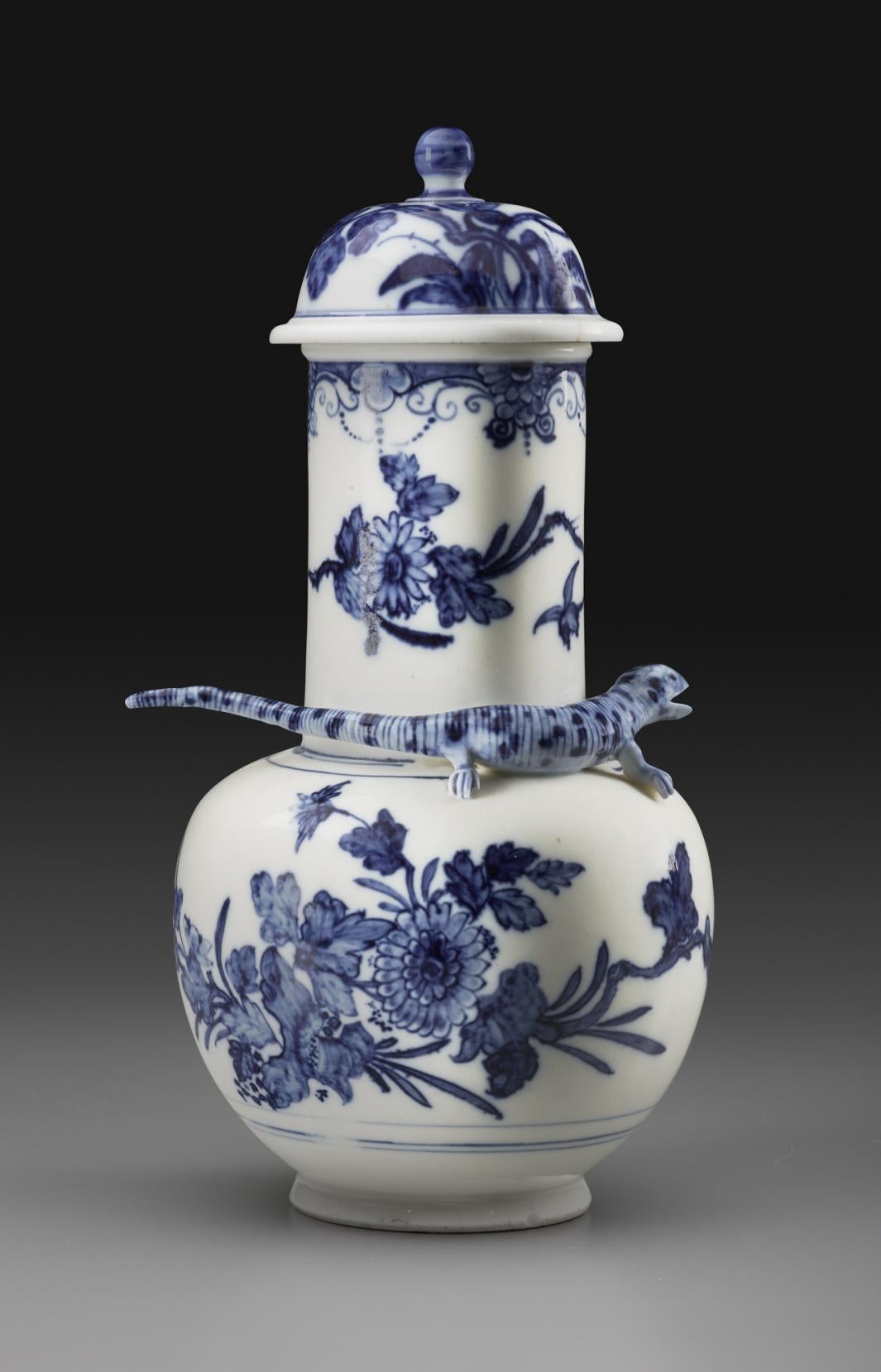 photo of white white porcelain vase decorated with blue flowers and salamander