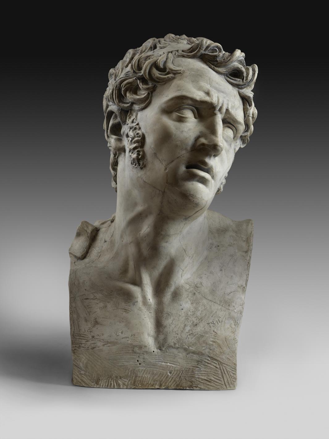 plaster sculpted bust of man, with brow furrowed and head turned (front view)