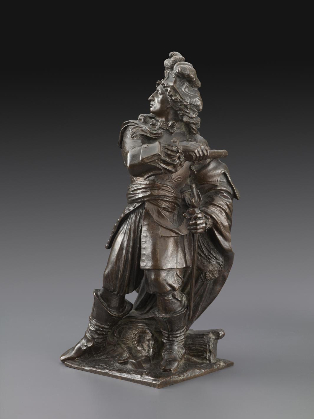 bronze sculpture of standing man in European military uniform, holding saber