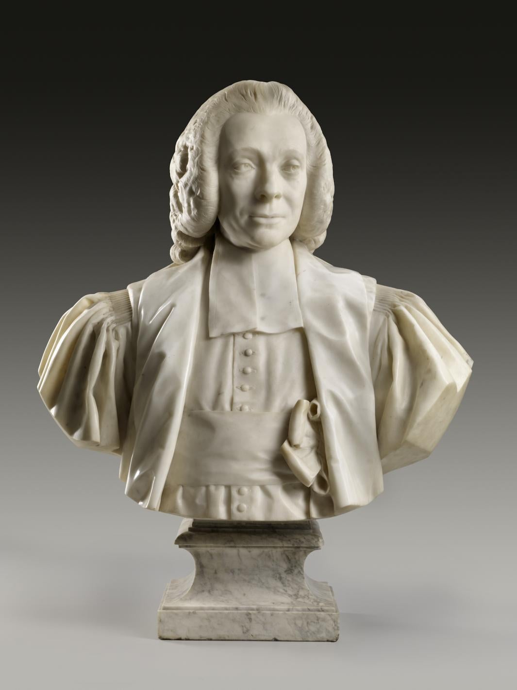 Marble bust of a man wearing a wig, robe, and bow-tied sash