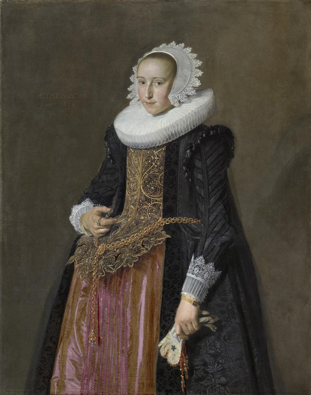 A painted portrait of a woman wearing a black cloak trimmed with white lace at the wrists and gold brocade down the front of her dress. She wears a white cap and white neck ruff and holds a glove in her left hand. 