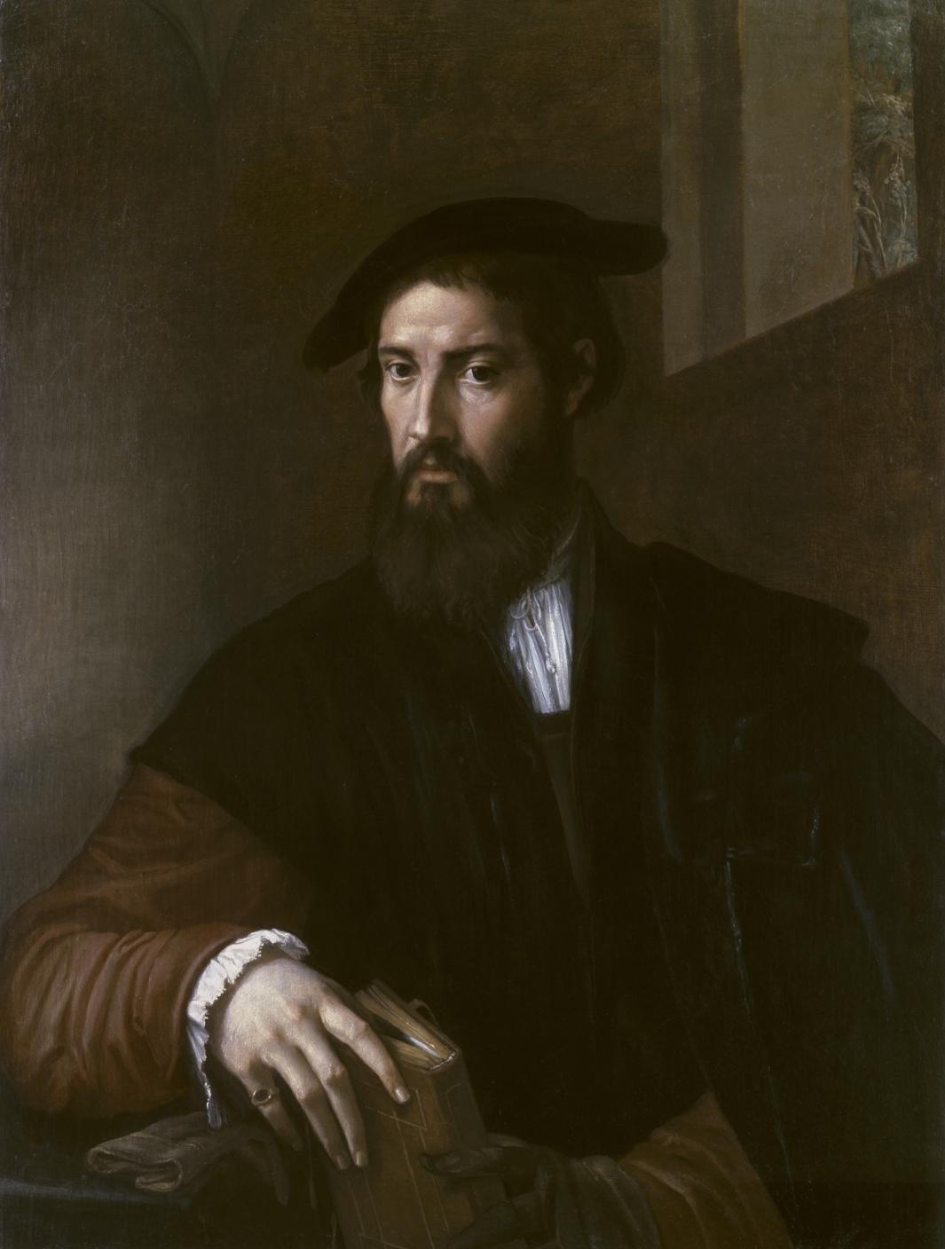 Painting of a half-length bearded man wearing a hat and holding a book