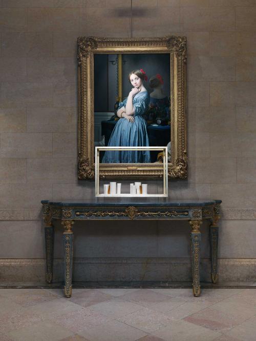 photo of white sculpture piece in front of oil painting of standing young woman in the Frick Collection gallery