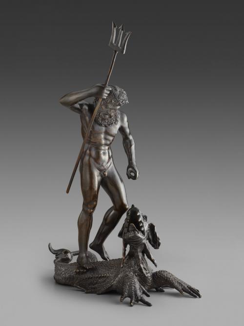 bronze sculpture of a standing man (Neptune) raising a trident over a sea monster