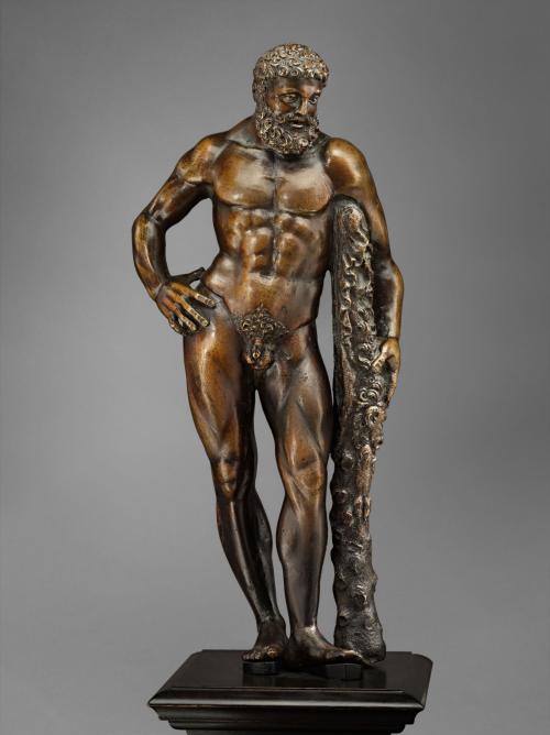 Bronze sculpture of a man standing with a club.