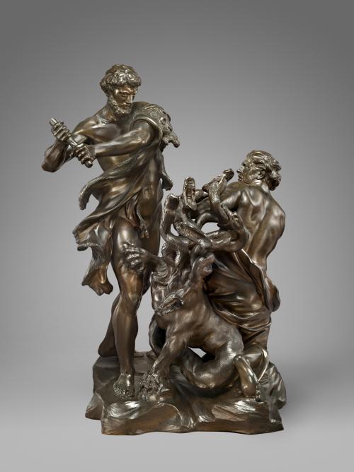 Bronze sculpture of two men attacking a monster.