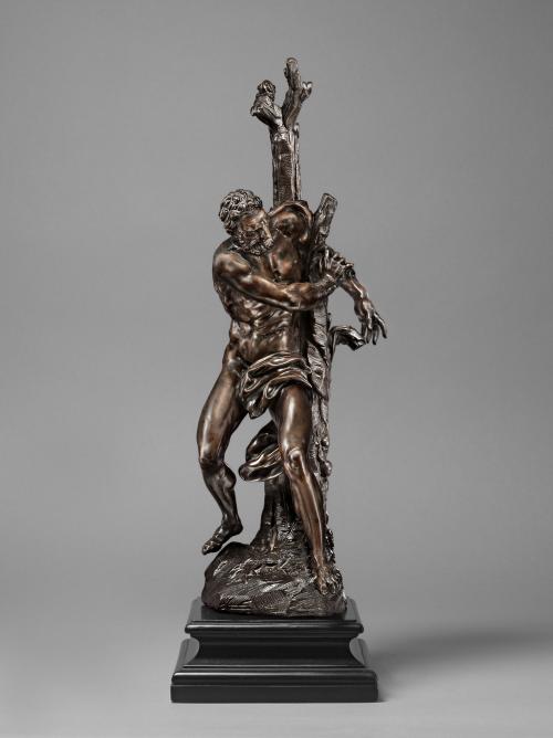 Bronze sculpture of man, bound to a tree.