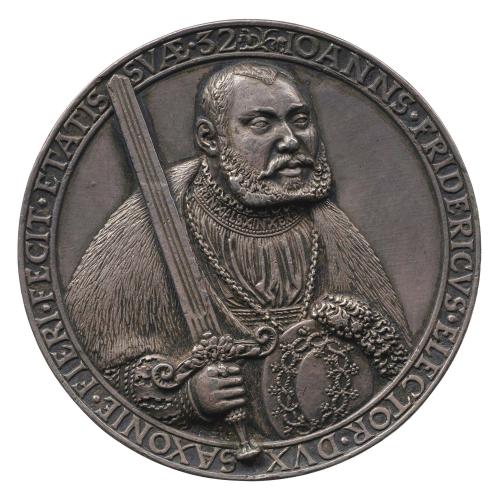 Silver portrait medal of Johan Friedrich of Saxony wearing a fur robe, holding a sword in his right hand and a shield in his left hand, with a chain around his neck, looking to the right