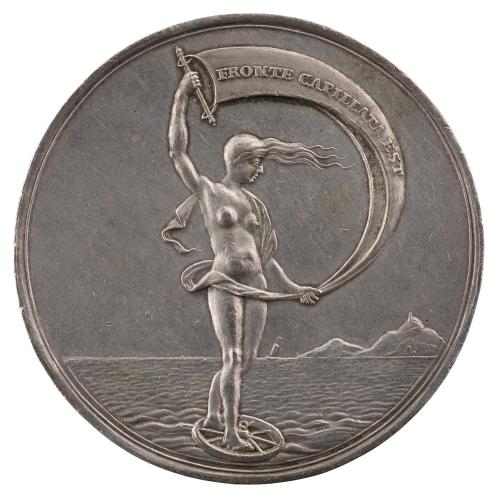 Silver medal depicting a female figure standing with a sail on a wheel in the sea 