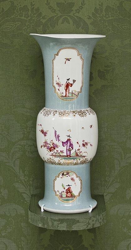 large turquoise and white vase decorated with flowers and figures