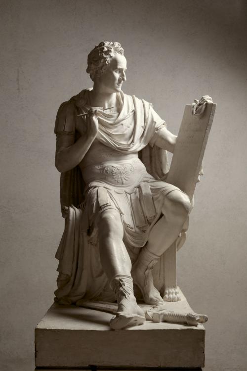 sculpture of George Washington seated holding tablet