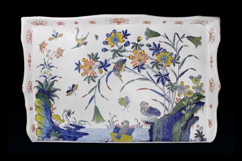 Earthenware tray with a landscape scene of large flowers on a riverbank with birds, insects and a small dragon.