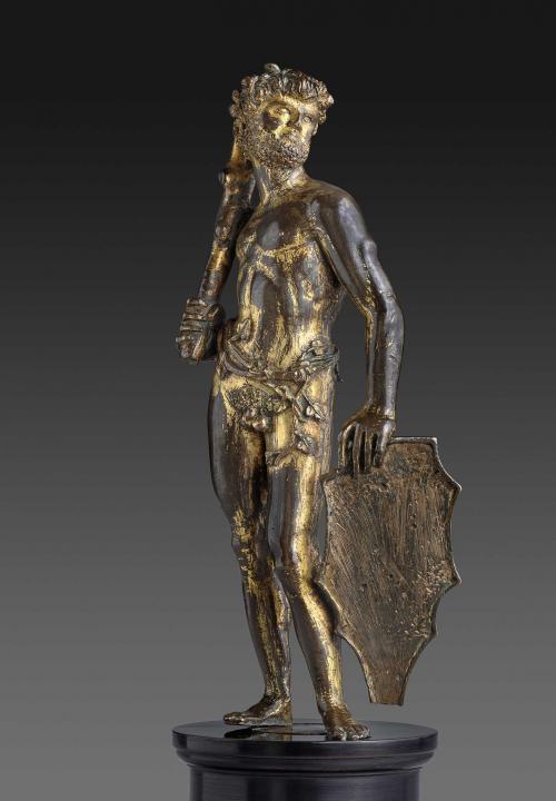 Bronze statuette of a man holding a shield and a club.