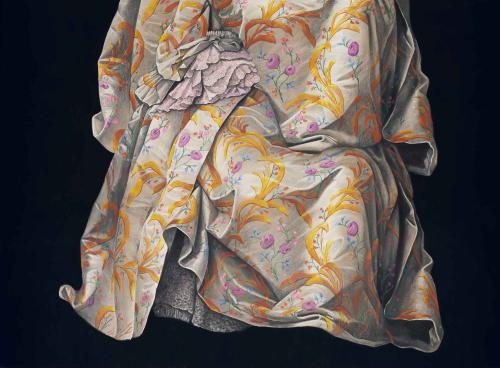 Image of off-white cloth with elaborate yellow and purple floral pattern on a black background, billowing down from the center in various folds and creases