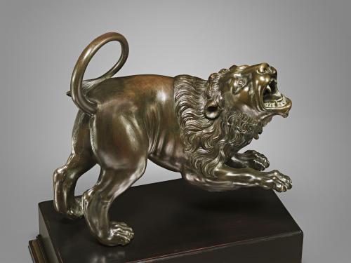 Bronze sculpture of a roaring lion.