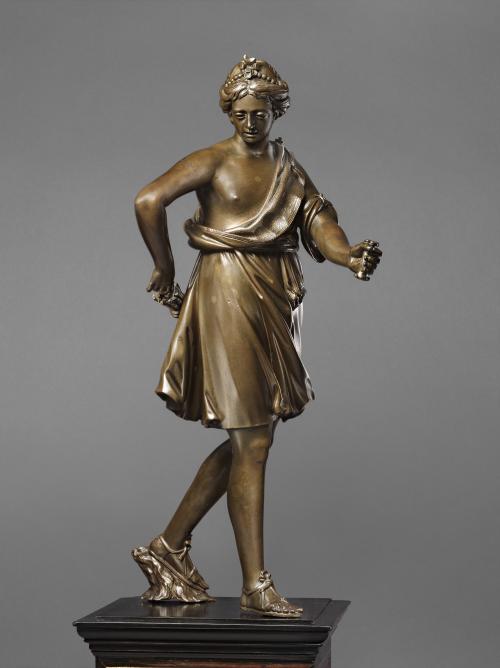 Bronze sculpture of a standing woman.