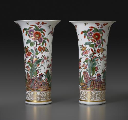 photo of white porcelain vases decorated with flowers and bird