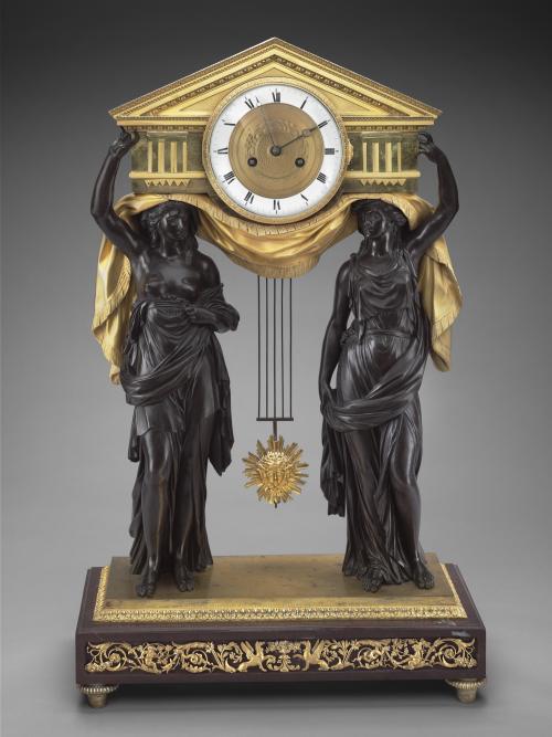 clock depicitng two carytids, (carving of a draped female figure, used as a pillar to support the entablature of a Greek building) in black bronze holding golden clock in Greek architecture