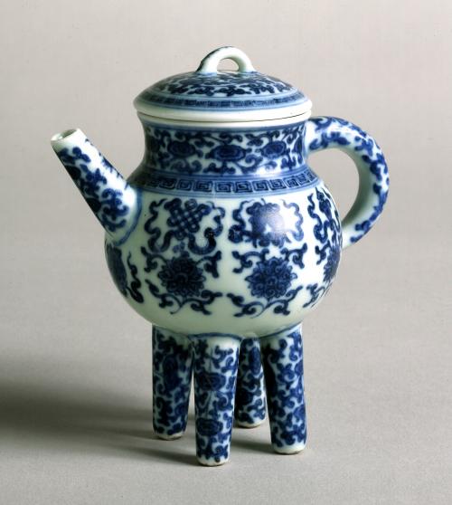 image of blue and white porcelain teapot with four legs.
